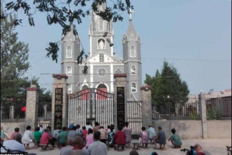 Chinese Catholics pray outside church