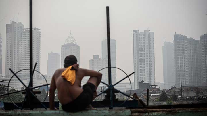 A man sitting donw looking at Jakarta