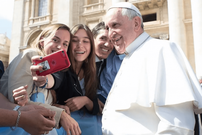 Pope Francis takes a selfie with pilgrims at the April 1, 2015 general audience in St. Peter’s Square. | Vatican Media.