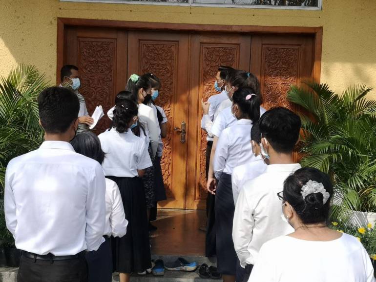 In a symbolic gesture,  15 adult candidates stood at the closed church door, wearing black and white clothes requestioning to seek baptism and be part of the Christian community.  A priest opened the church door and asked: What can I help you?  The candidate responded, “I ask to enter the church.” The ceremony was held at Saint Peter and Saint Paul Church in Phnom Penh city on February 20. 