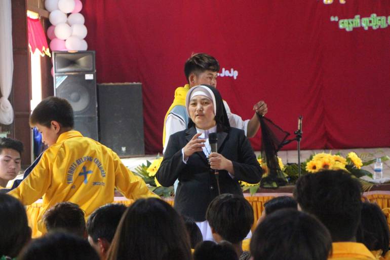 Sister Theresa Nan San is teaching catechism to the children