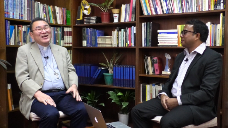 Archbishop Isao Kikuchi speaks to Fr. Kasmir Nema