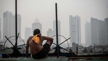 A man sitting donw looking at Jakarta