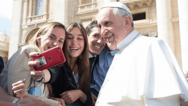 Pope Francis takes a selfie with pilgrims at the April 1, 2015 general audience in St. Peter’s Square. | Vatican Media.